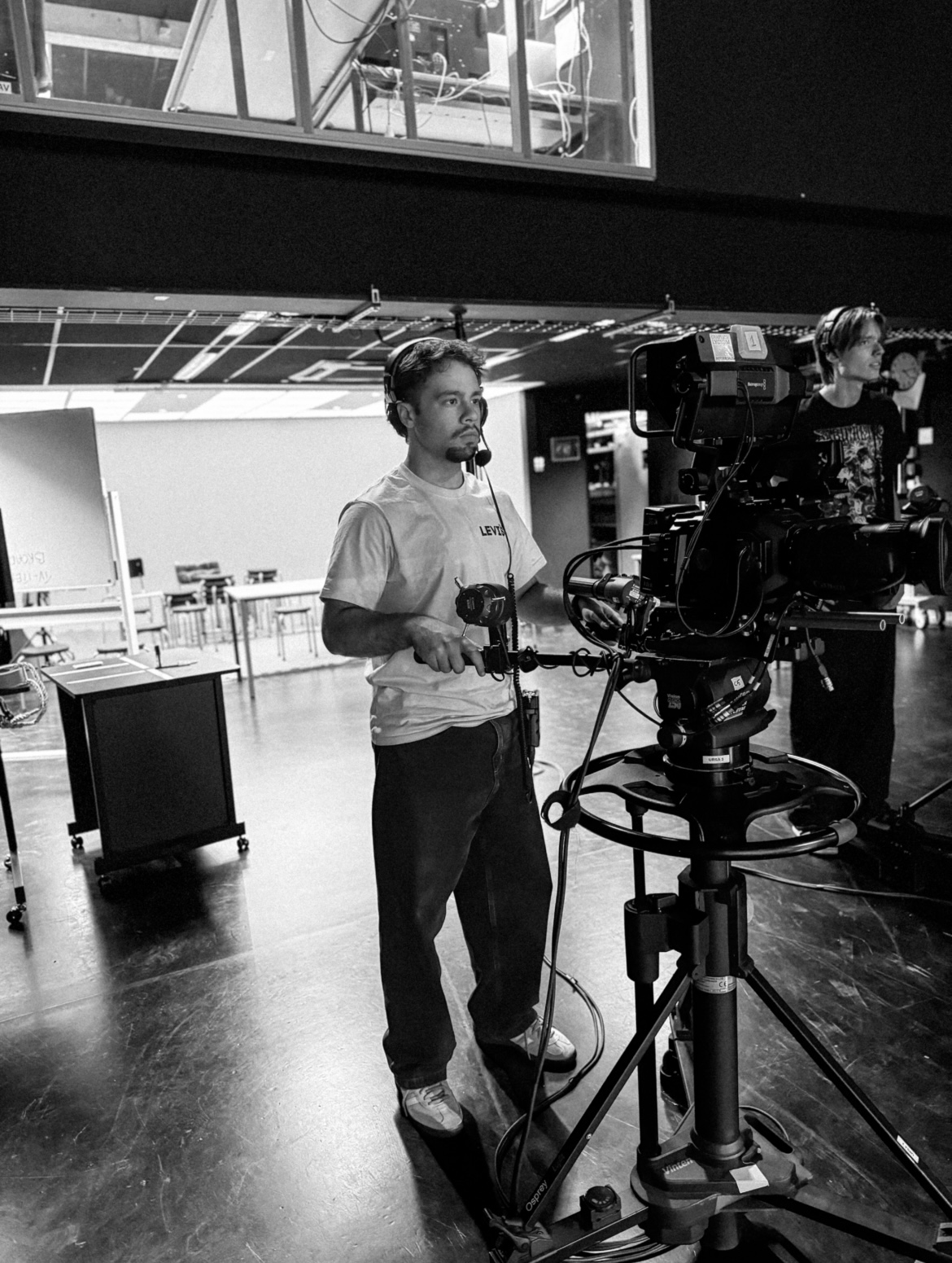 Yasin Bektas behind a studio camera wearing a headset
